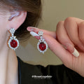 Silver Tone Crystal Oval Drop Earrings With Glossy Red Centers view 1