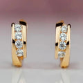 Gold Tone Four Stone Cross Band Huggie Hoop Earrings view 1