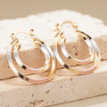 Gold Tone Triple Hoop Earrings With White And Pink Bands view 3