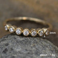 Gold Tone Bezel Set Seven Stone Thin Band Ring Sizes 6-10 view 5