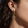 Long Crystal Wave Drop Earrings in Polished Gold Tone view 4