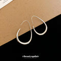 Polished Teardrop Hook Earrings In Gold And Silver view 1