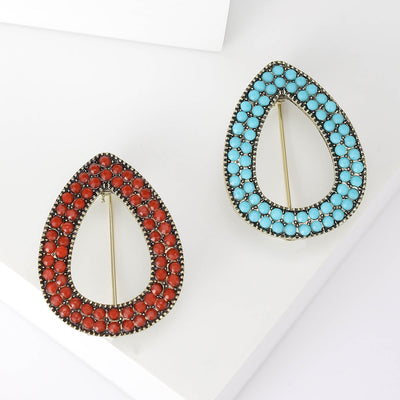 Front view of open teardrop beaded brooch in turquoise blue and red