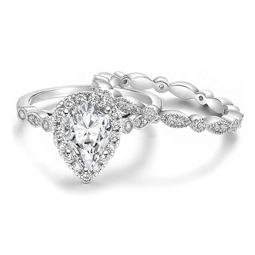 Silver pear halo engagement ring paired with marquise eternity band