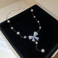 Silver Tone Bow And Pearl Station Necklace With Decorative Accents view 2