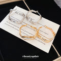 Wavy Open Hoop Earrings In Polished Gold And Silver Tones view 4