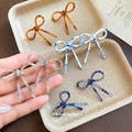 Slim Bow Stud Earrings In Brown Blue And White Patterns view 1