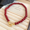 Glossy Red Beaded Necklace with Gold Tone Clasp Fashion Jewelry view 2