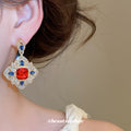 Red Center Ornate Crystal Drop Earrings with Polished Metal Tone Details view 3