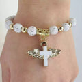 White And Gold Tone Cross Bead Bracelet With Winged Cross Charm view 3
