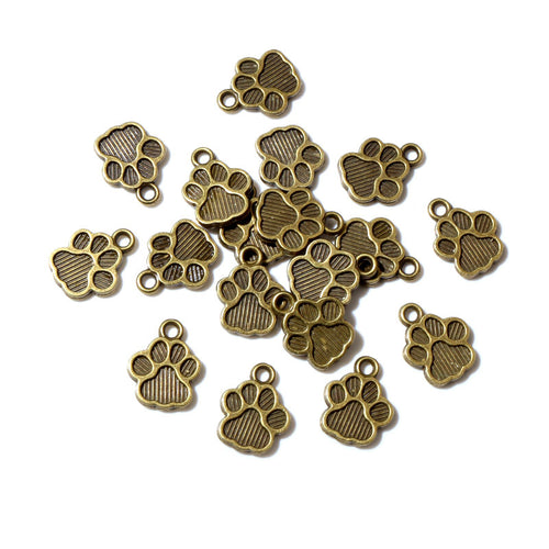Detail view of openwork paw-print silhouettes in antique bronze and silver tones