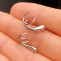 Silver Tone Sculptural Swirl Cuff Earrings with Polished Finish view 4
