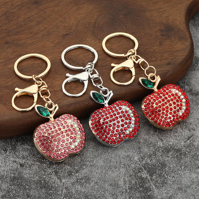 Three rhinestone apple keychains in red and pink stones