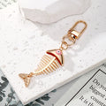 Gold Tone Fish Skeleton Evil Eye Clip Keychains in Five Colors view 2