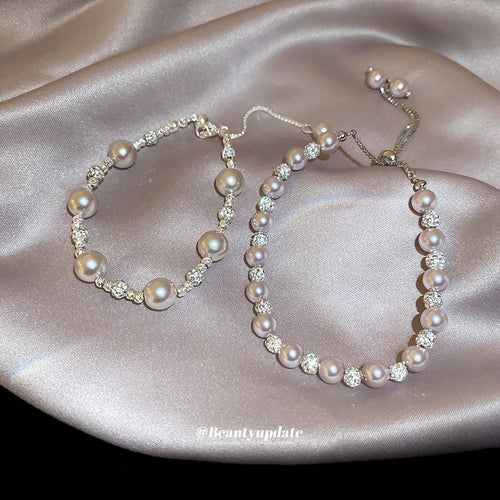 Dense and large-pearl pink bracelets laid on satin fabric