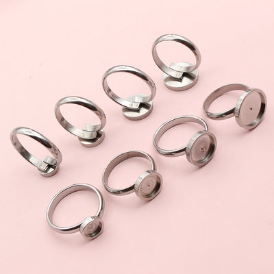 stainless steel round-pad ring blank assortment on a light background