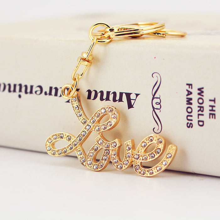 Gold Tone Rhinestone Love Script Keychain With Lobster Clasp