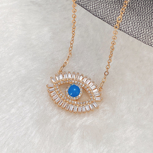 Blue Eye Pendant Necklace with Clear Halo in Gold Tone shown in alternate angle
