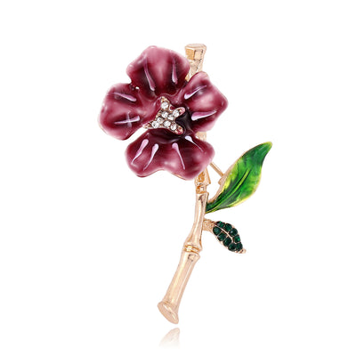 Front view of the burgundy flower metal brooch