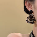 Black Leopard Floral Resin Drop Earrings with Polished Details view 3