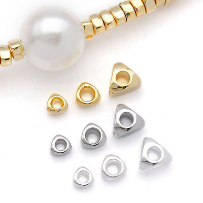 Triangular metal spacer beads in three sizes arranged as a full product overview