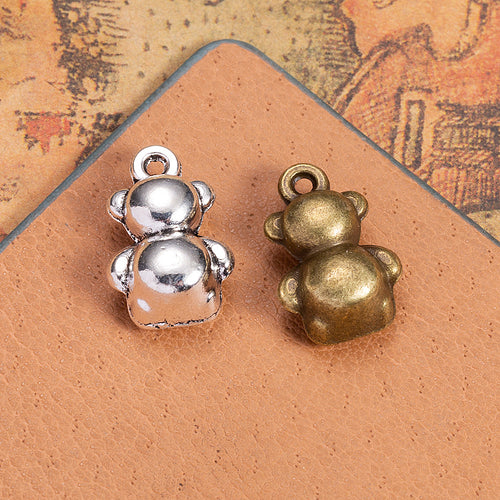 Second product image of the dimensional teddy bear charm showing a rounded three-dimensional seated teddy bear with a to
