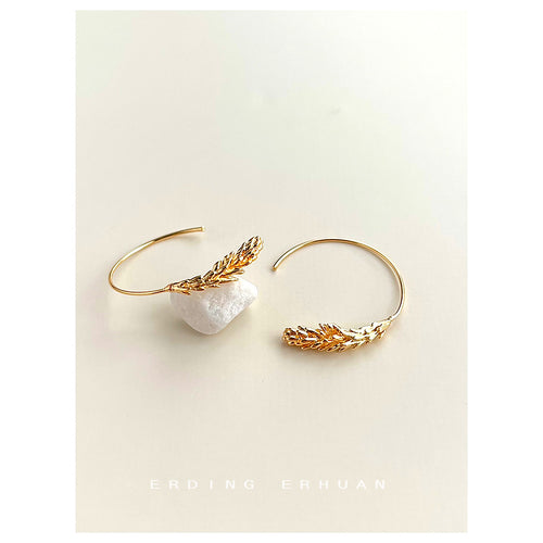 Gold-tone sculpted-wheat-ear curved hooks shown worn on an ear.