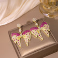 Gold Tone Crystal Pave Bow Drop Earrings Clear Colored Stones view 3