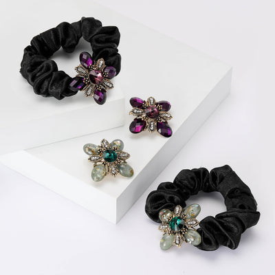 Grouped view of green and purple flower brooch and scrunchie styles arranged together.