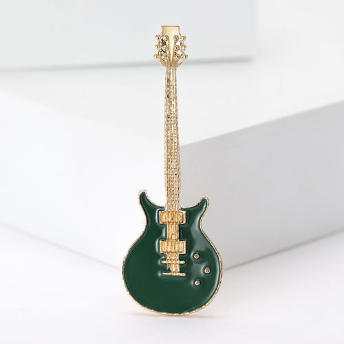 Dark green enamel gold-tone electric guitar brooch close-up