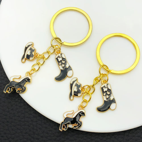 Alternate arrangement of the black brown white and pink western horse metal keychain showing its hardware and charm deta