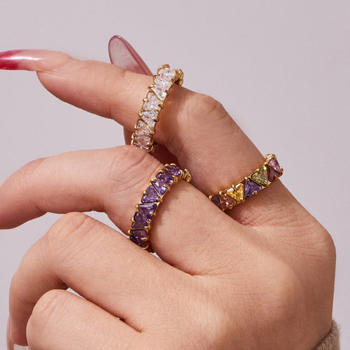 Styled hand view of triangle crystal eternity rings in main image 2.