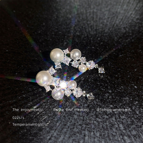 Silver pearl zircon cascade earrings with light flare