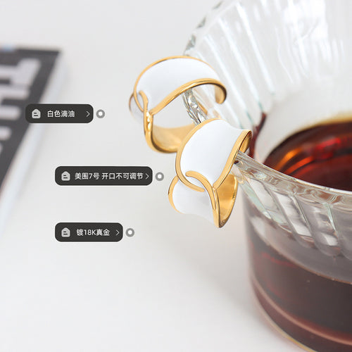 White enamel gold open rings on glass pitcher with printed feature tags