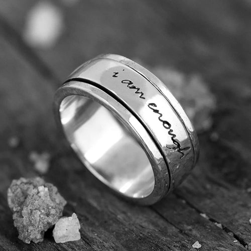 Black and white close-up of spinner band showing full engraved phrase