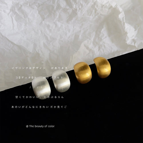 Brushed rounded-square stud earrings in gold and silver tones shown as both metal colors.