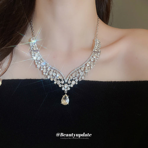 silver-tone floral leaf V crystal necklace and teardrop earring set shown worn in a styled second view