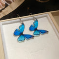 Blue Butterfly Drop Earrings in Clip On and Hook Styles view 7