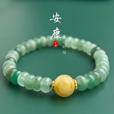 Green frosted rondelle bracelet with yellow center on green background