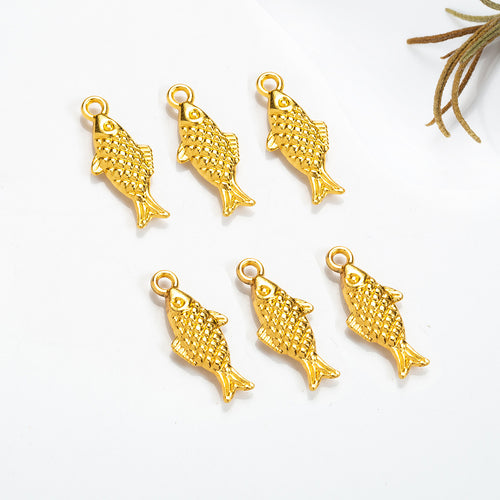 Second product image of the textured fish charm showing a small double-sided fish with crosshatched scale texture