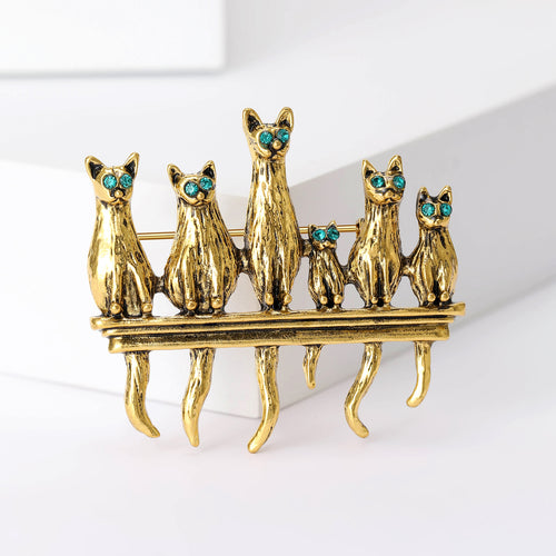 Gold tone six cats on fence brooch close-up front view