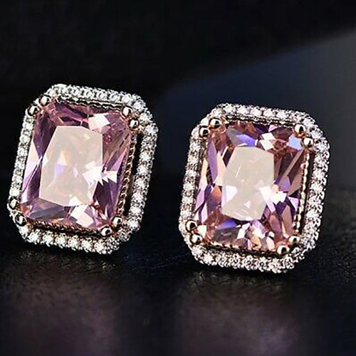 Close pair of pink rectangular studs on dark background