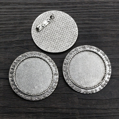 round cabochon brooch settings shown in a close detail view