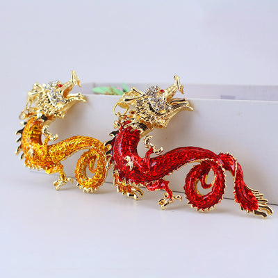 Red and gold dragon charms displayed side by side against a white background.