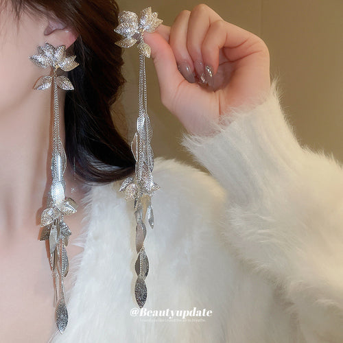 silver tone layered leaf vine long drop stud earrings shown in a clear product view