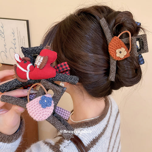 Red horse and crochet bag claw clips held and worn in brunette bun