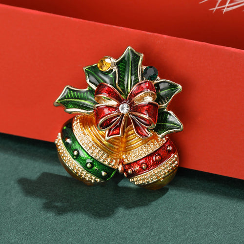Christmas bells brooch on red and green holiday surface