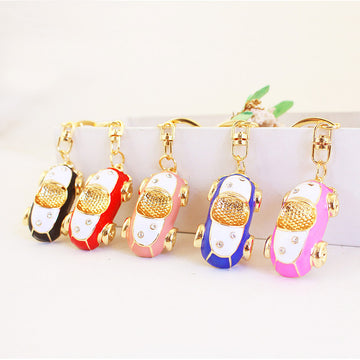 Car-Shaped Metal Keychain With Gold-Tone Trim and Clear Stone Accents