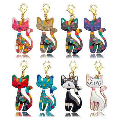 Eight colorful patterned cat charms arranged in two rows on a white background.