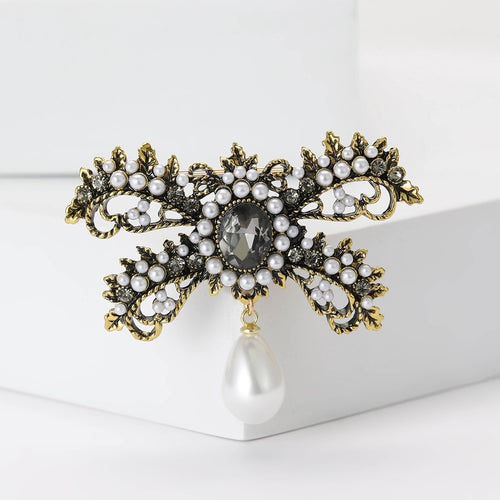Pearl and Crystal Ribbon Bow Brooch with Teardrop Dangle front view on a white background